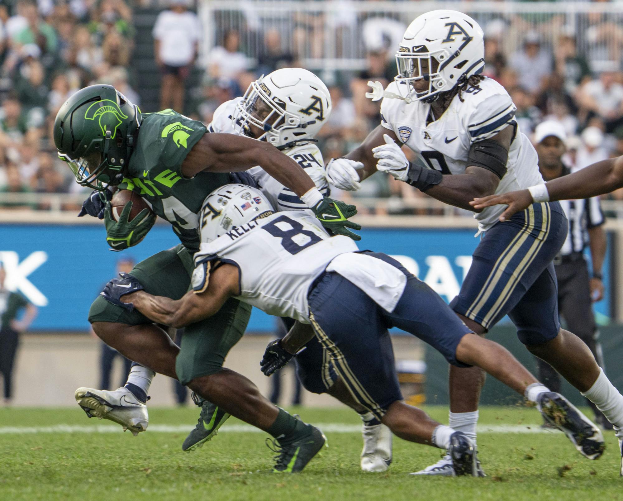 Redshirt senior running back Elijah Collins, 24, breaks through the defense during Michigan State’s game against Akron on Sat., Sept. 10, 2022 at Spartan Stadium. The Spartans earned a decisive victory with a final score of 52, zip. 