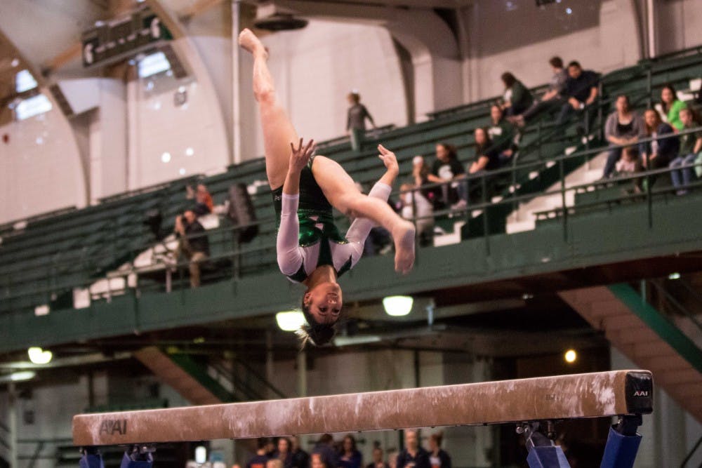 Junior Molly Hoerner O'Malley performs her beam routine during the Big Five meet on March 17, 2018, at Jenison Fieldhouse. The Spartans finished fifth out of the five schools at the meet.