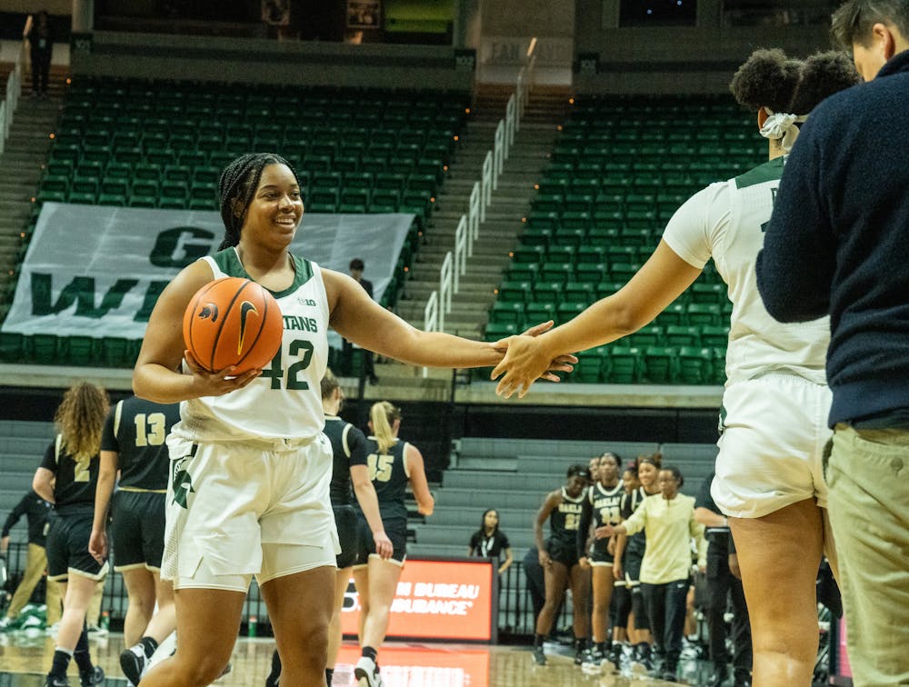 <p>Freshman guard Olivia Porter (42) high fives her teammate at the game against Oakland at the Breslin Center on Nov. 15, 2022. The Spartans defeated the Grizzlies 85-39. </p>