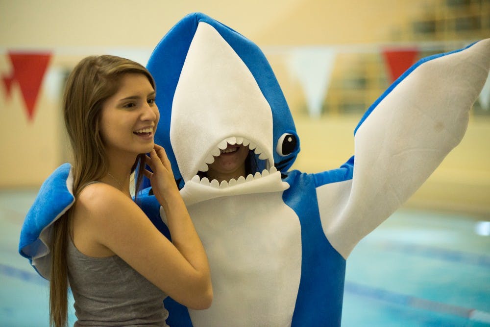 <p>Grand Ledge resident Megan Valo, left, poses for a picture with zoology junior Tasha Christensen during Shark Night on Nov. 20, 2015 at IM Sports-Circle. The Shark Club cohosted the event with the University Activities Board and the evening was based off of Discovery Channel's Shark Week. </p>