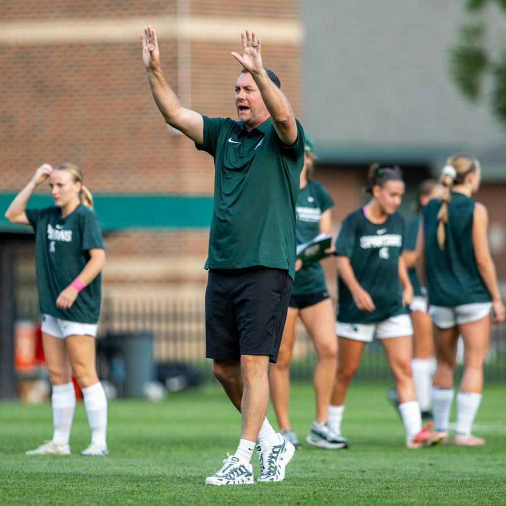<p>Michigan State head women's soccer coach, Jeff Hosler, talks with players while they are warming up in DeMartin Stadium in East Lansing, Mich., on Aug. 12, 2026.</p>