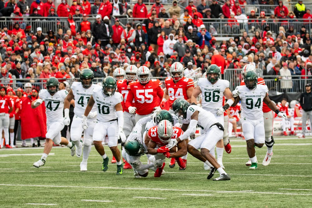 <p>Michigan State tackles Ohio State&#x27;s Master Teague III (33) during Michigan State&#x27;s loss to Ohio State on Nov. 20, 2021.</p>