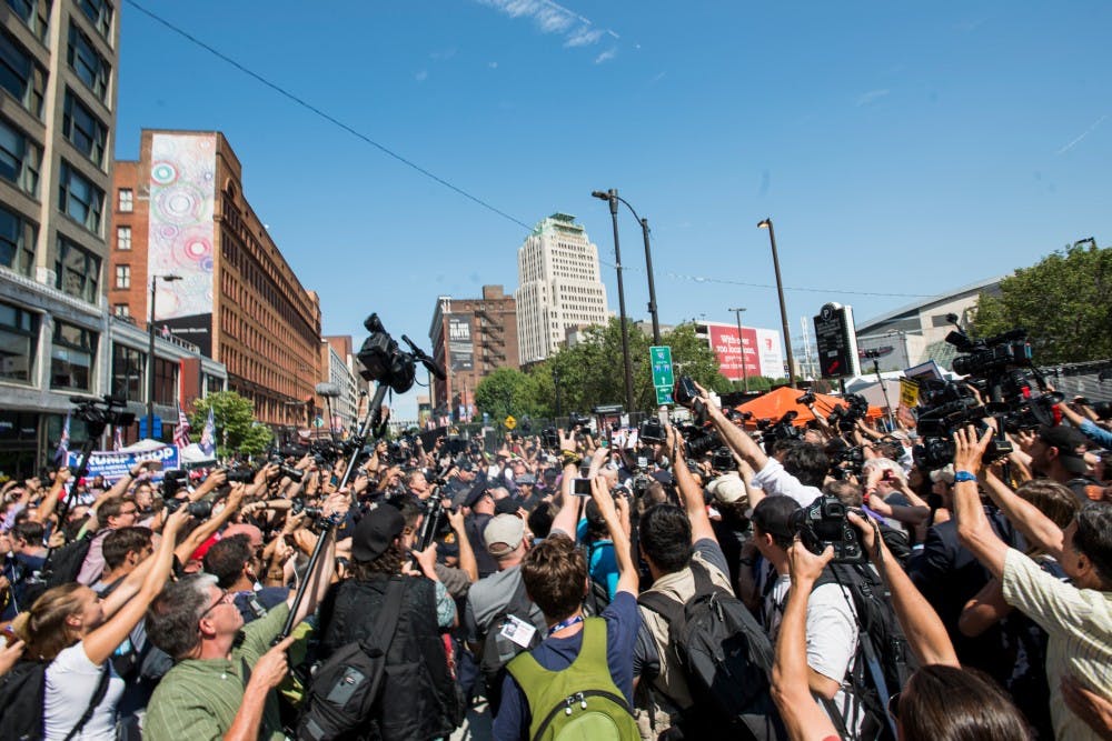 Members of the media surround members of the Revolutionary Communist Party as they burn an American flag on July 20, 2016, the third day of the Republican National Convention, in Cleveland, Ohio. 