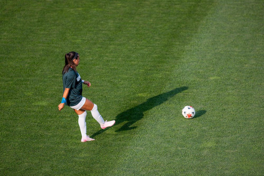 <p>Michigan State Sr. M, Bella Najera (23), passes the ball to her teammate while warming up for a game in DeMartin Stadium in East Lansing, Mich., on Aug. 12, 2026.</p>