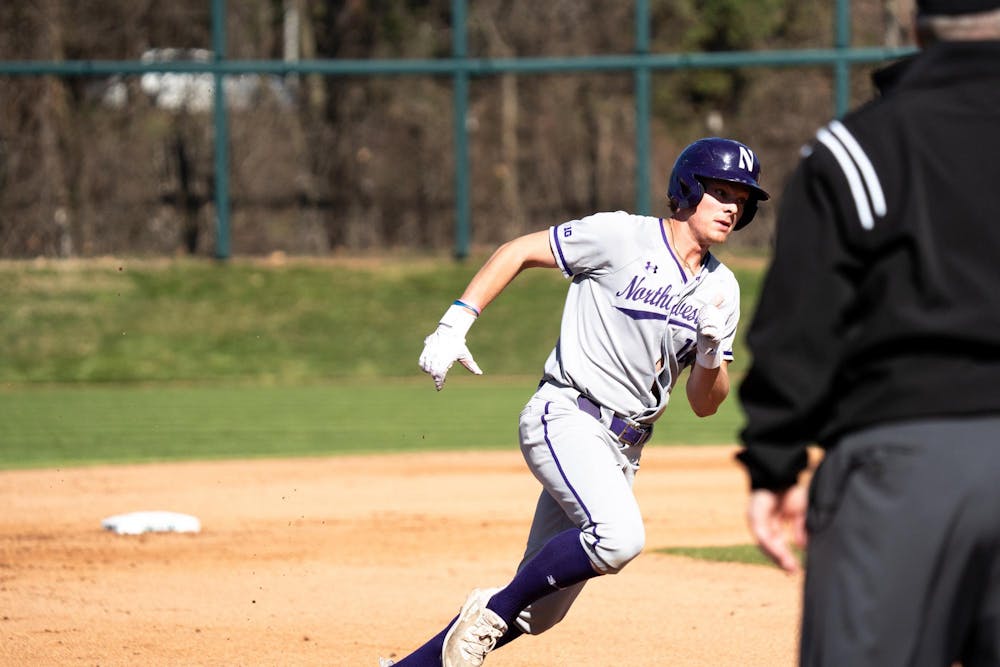 Northwestern junior infielder Owen McElfatrick (8) runs to second base at Jeff Ishbia Field on April 12, 2025