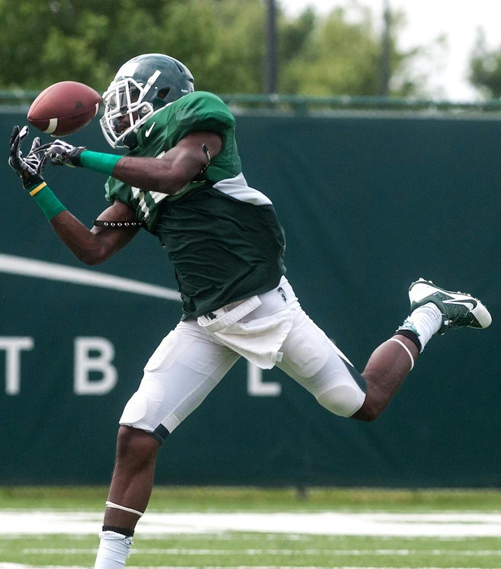 <p>Senior wide receiver Tony Lippett participates in practice drills, Aug. 6, 2014, at the practice field outside Duffy Daugherty Football Building. The football season kicks off on Aug. 29 with a game against Jacksonville State. Jessalyn Tamez/The State News</p>