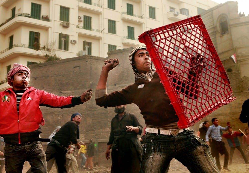 Anti-Hosni Mubarak protesters throw rocks at rival group at the edge of Liberation Square, where they clashed for a second day in Cairo, Egypt, on Thursday, February 3, 2011. The protesters were able to push back the rival group several blocks, but the fighting continues unabated. (Carolyn Cole/Los Angeles Times/MCT)
