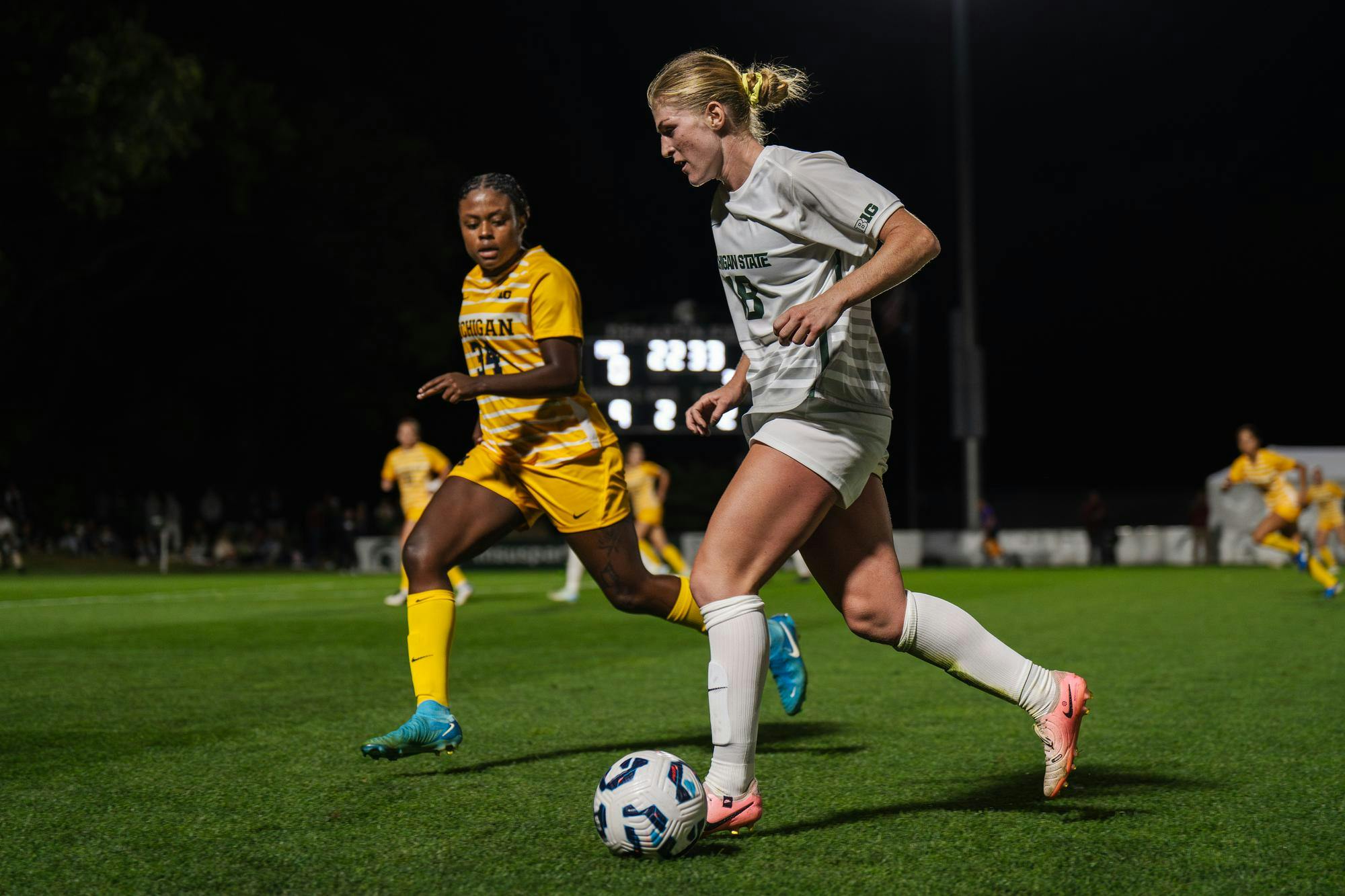 Michigan State graduate student midfielder Justina Gaynor (18) dribbles the ball down the field at DeMartin Stadium on Oct. 5, 2024. The Spartans took victory over the Wolverines in an intense match ending with a score of 1-0, the only point being scored by Gaynor. 