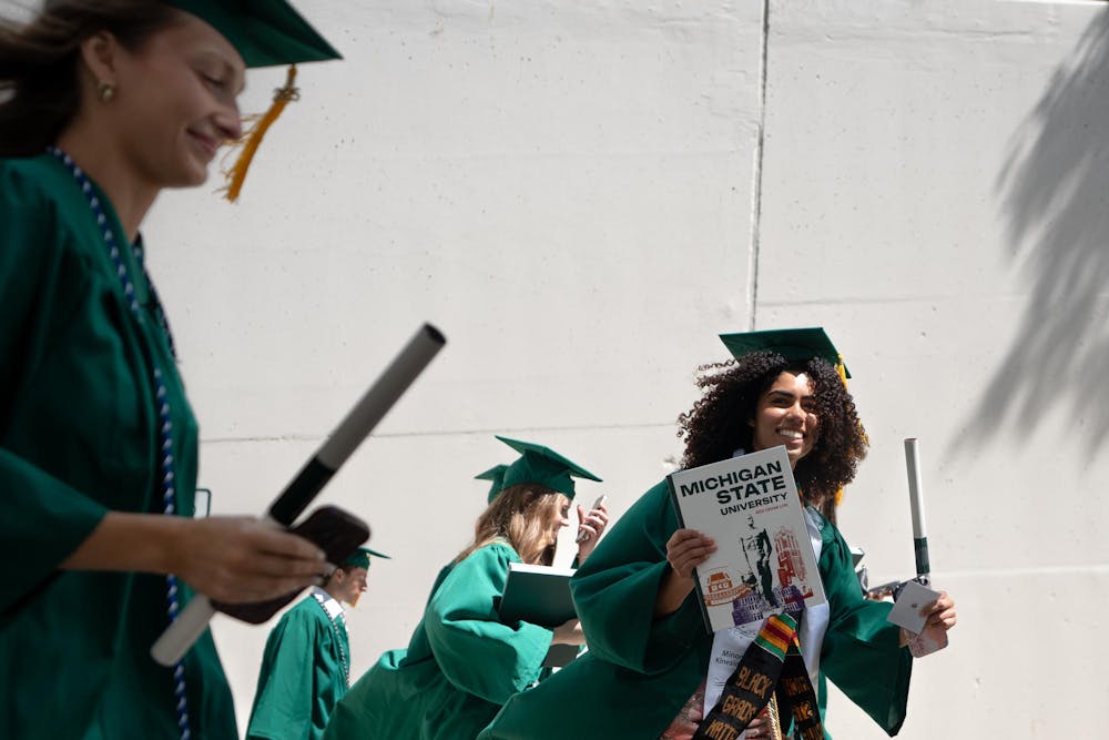 Graduates walk out of the Breslin Center tunnel after commencements on May 3, 2025.