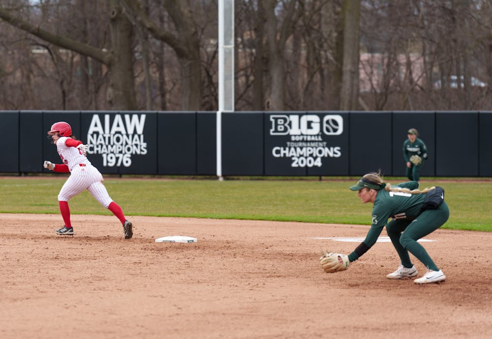 <p>Michigan State fifth-year Caitie Ladd guards second as Nebraska sophomore Caitlynn Neal goes for third base. Spartans lost 6-0 against Nebraska, on April 9, 2022.</p>