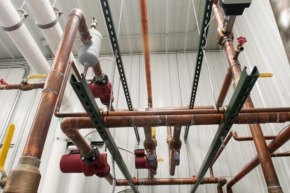 	<p>Pipes lead to a boiler connected to an anaerobic digester on Monday, Nov. 26, 2012, behind the <span class="caps">MSU</span> Dairy Teaching and Research Center. The anaerobic digester creates renewable energy from recycled organic matter, such as food waste and cow manure. Julia Nagy/The State News</p>