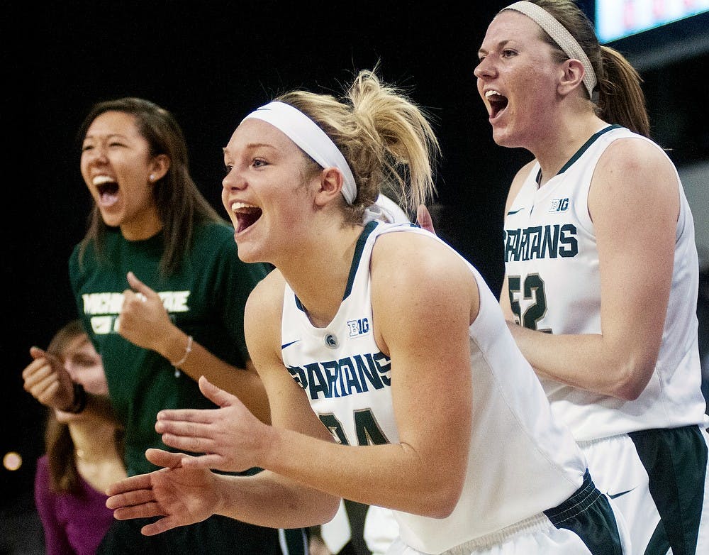 From left to right, sophomore center Madison Williams, senior forward Courtney Schiffauer, sophomore forward Becca Mills cheer during the quarterfinals of the Big Ten Tournament against Michigan on March 8, 2013, at Sears Centre in Hoffman Estates, Ill. The Spartans defeated the Wolverines 62-46. Julia Nagy/The State News