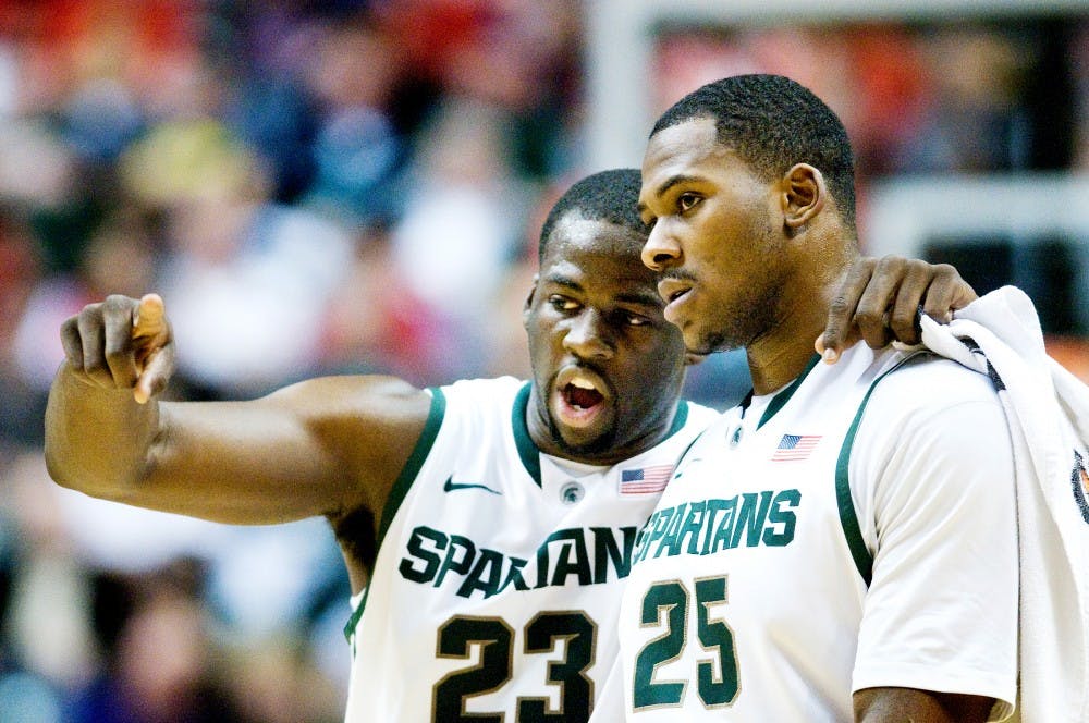 Senior forward Draymond Green talks with junior center Derrick Nix before Nix attempts a free throw. The Michigan State Spartans win their first Big Ten Tournament in 12 years by defeating the Ohio State Buckeyes, 68-64, Sunday afternoon at Bankers Life Fieldhouse in Indianapolis. Justin Wan/The State News