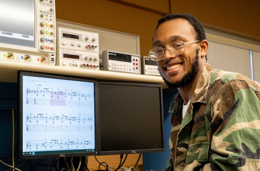 Computer engineering senior Timothy Boyd playing music on computers in a lab at Michigan State University's College of Engineering on Sept. 21, 2022. 