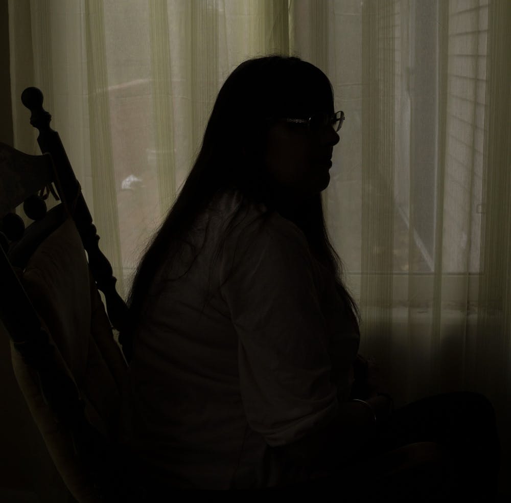 Terri sits inside her home on November 3, 2019. She has faced abuse and unstable housing and homelessness her entire life, but is now an activist speaking about the realities of homelessness, domestic violence and other forms of abuse across Michigan. 