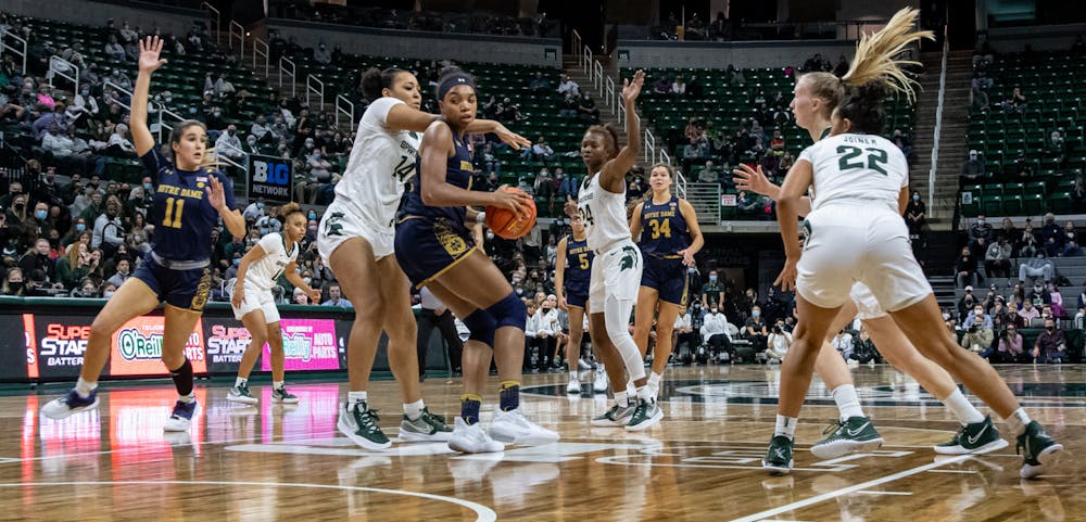 Michigan State's Taiyier Parks (14) defends against Notre Dame's Maya Dodson (0) during Michigan State's loss on Dec. 2, 2021.