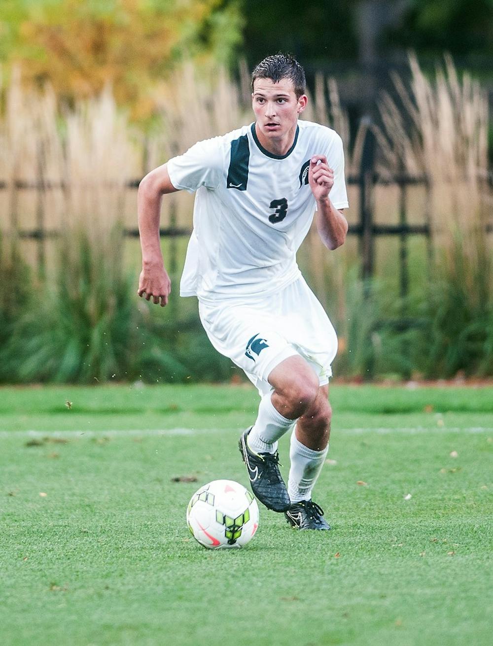 <p>Freshman defender Jimmy Fiscus looks to pass the ball downfield Oct. 7, 2014, during a game against Akron at DeMartin Soccer Stadium at Old College Field. The Spartans defeated the Zips, 1-0. Erin Hampton/The State News</p>