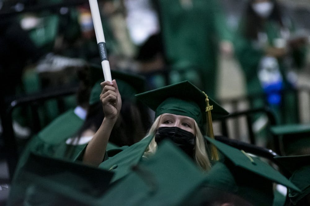 <p>A baccalaureate graduate with their diploma at the 2020 graduate and spring and summer 2021 graduate commencement ceremony at the Breslin Center on Sept. 18, 2021.</p>