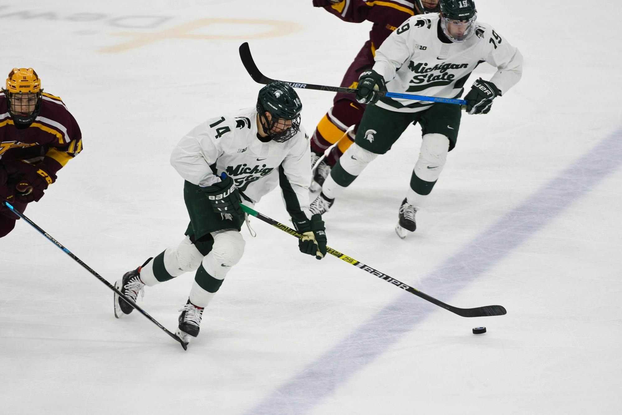 Sophomore forward Adam Goodsir (14) receives a pass during the hockey game against Minnesota at the Munn Ice Arena on January 10, 2020. The Spartans defeated the Golden Gophers 4-1. 