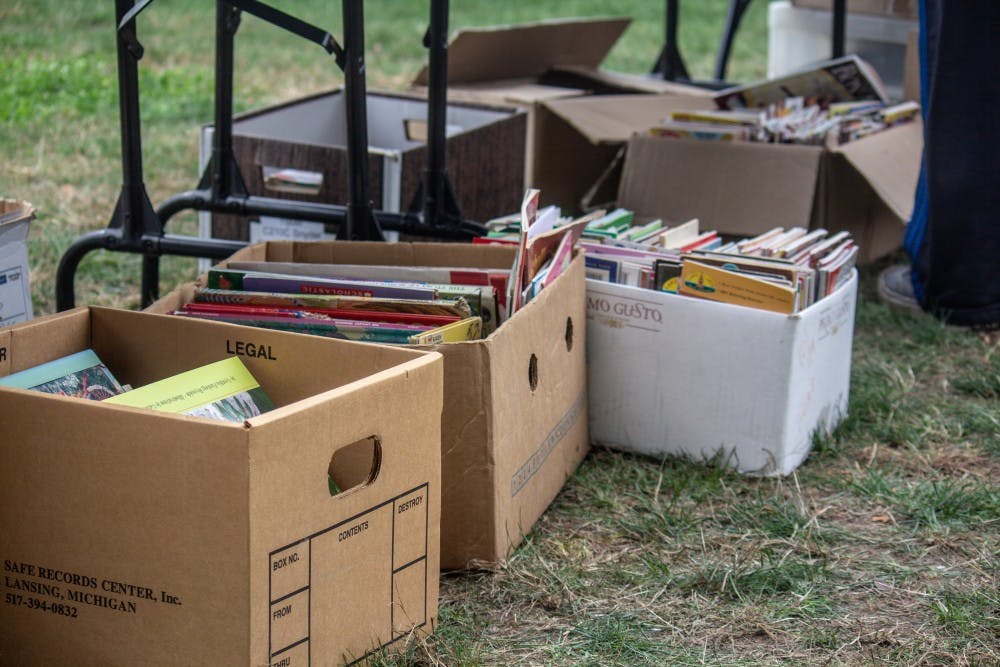 <p>Students look at books at the RCAH Annual Book Sale on the corner of Farm Lane and North Shaw Lane on Sept. 27, 2018.</p>