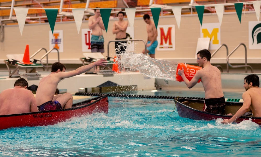 A student pours water into another team’s boat during a game of battleship at IM Sports West on April 19, 2019.