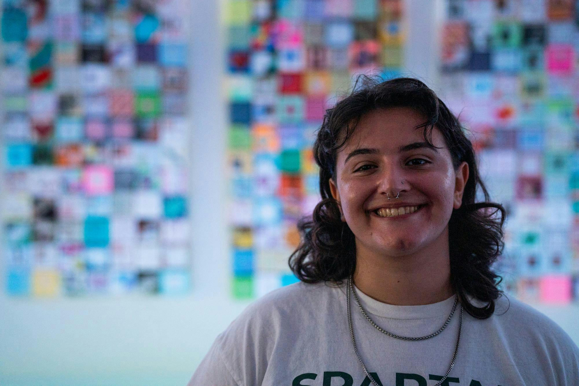 Maya Manuel, a Michigan State graduate poses for a photo in the East Lansing Public Library on June 25, 2024. The library debuted a "Soul Box" exhibit with the intention of communicating the devestating impacts of gun violence.