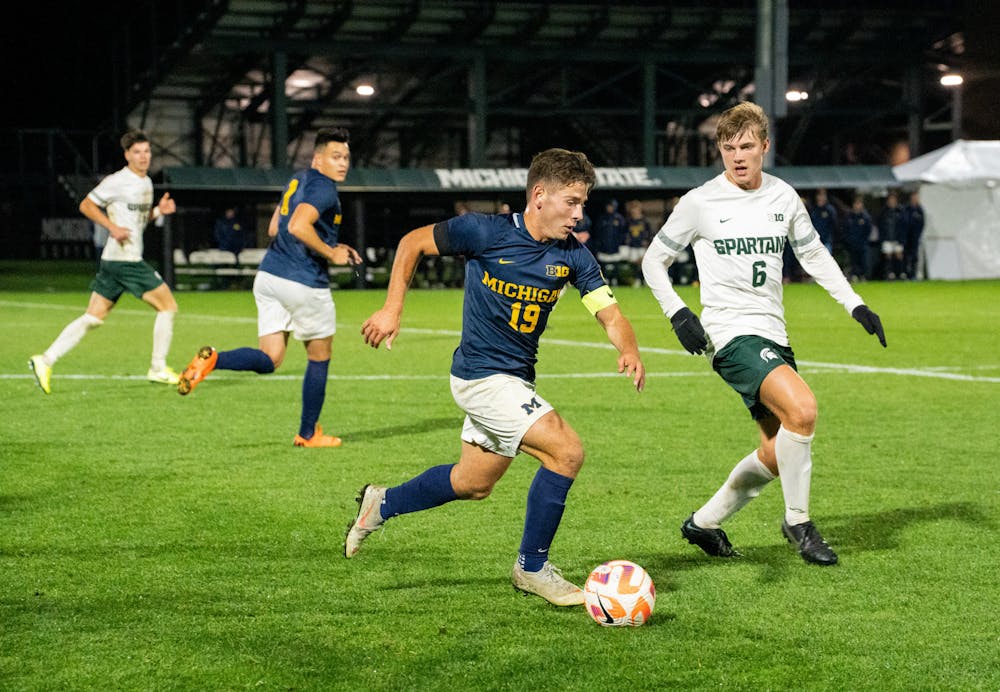 <p>University of Michigan graduate student midfielder Kevin Buca (19) dribbles the ball at DeMartin Stadium on Sept. 27, 2022. Spartans defeated the Wolverines 2-0. </p>