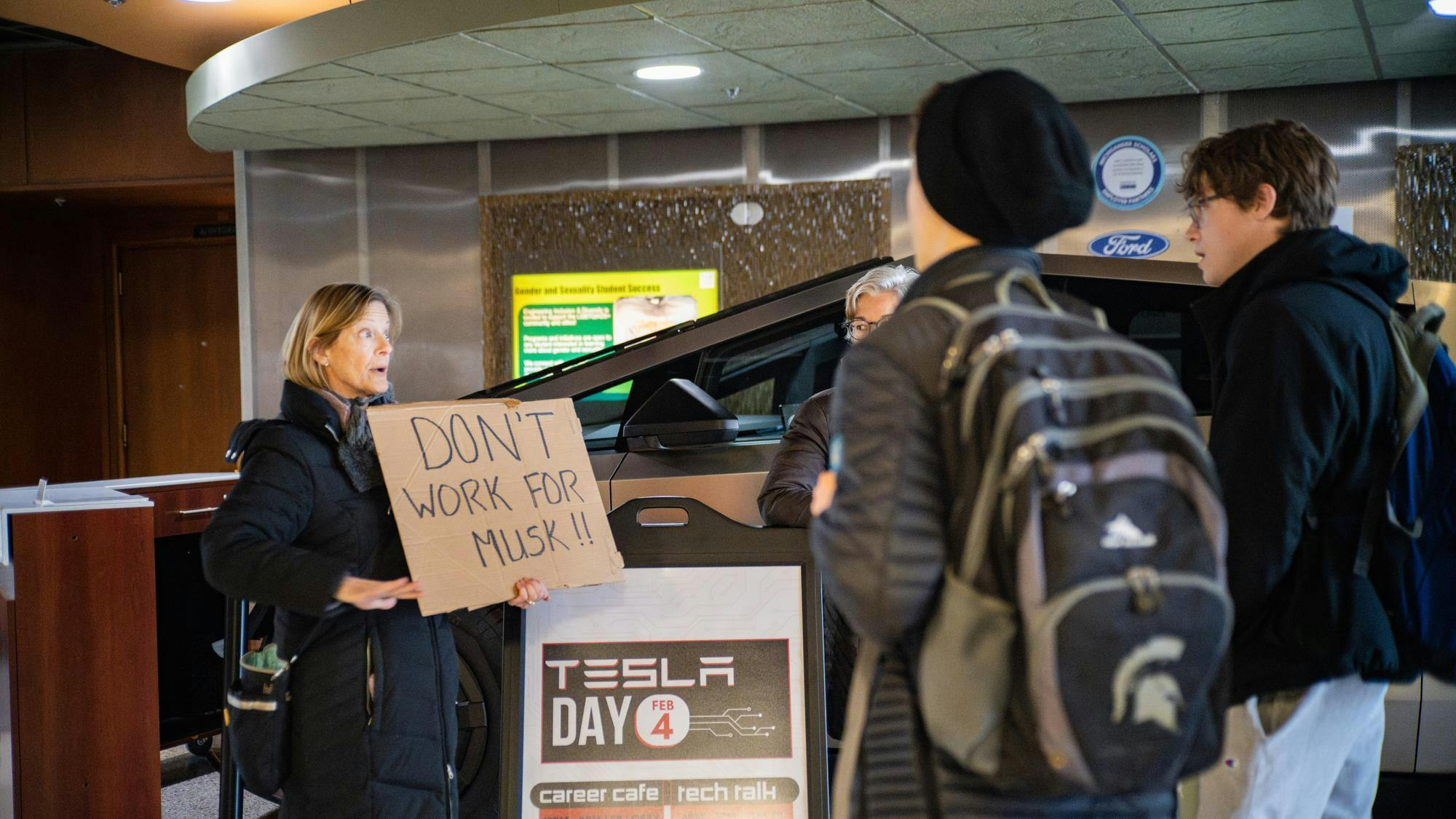 <p>Protest group standing next to the Tesla Cybertruck at the Engineering Building during the career week on February 3, 2025</p>