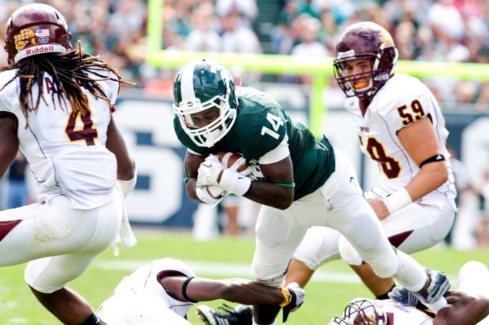 Then-redshirt freshman wide receiver Tony Lippett clutches the ball as he is tackled on Sept 24, 2011 at Spartan Stadium. State News File Photo