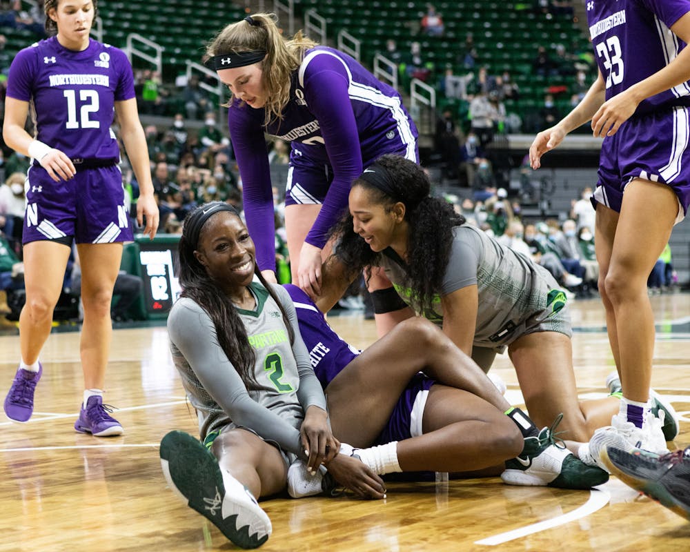 <p>Players ended up on the ground after the ball wound up in the air, tumbling on eachother during the Spartans&#x27; 65-46 win against Northwestern on Jan. 16, 2022. </p>