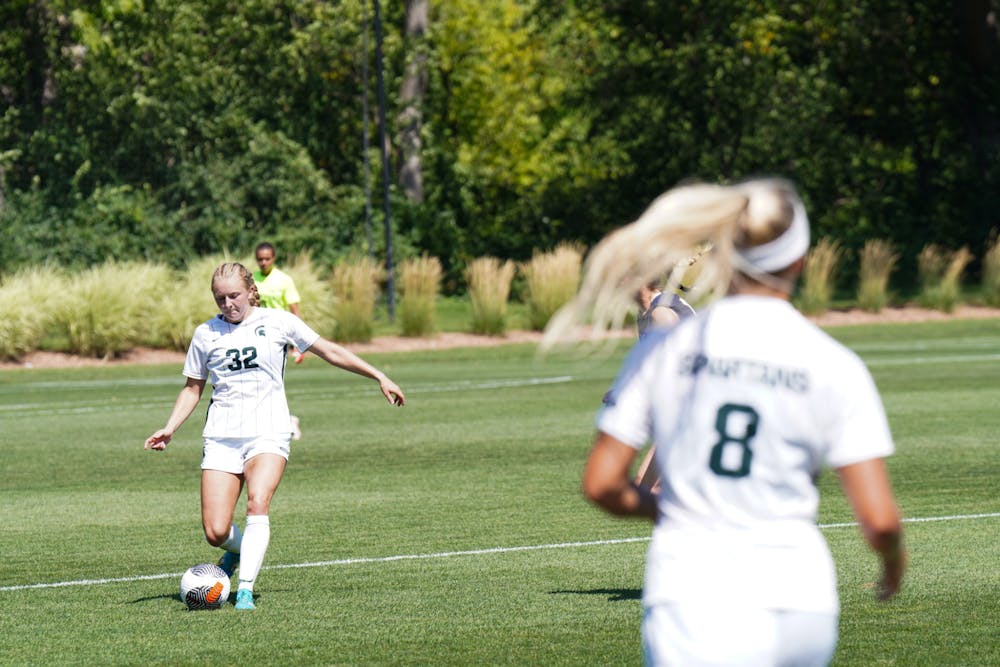 <p>Michigan State women's soccer forward Maggie Illig, #32, kicks the ball towards graduate defender Reagan Cox, #8, against Notre Dame at DeMartin Soccer Complex on Sept. 3, 2023. The Spartans lost 2-1.</p>