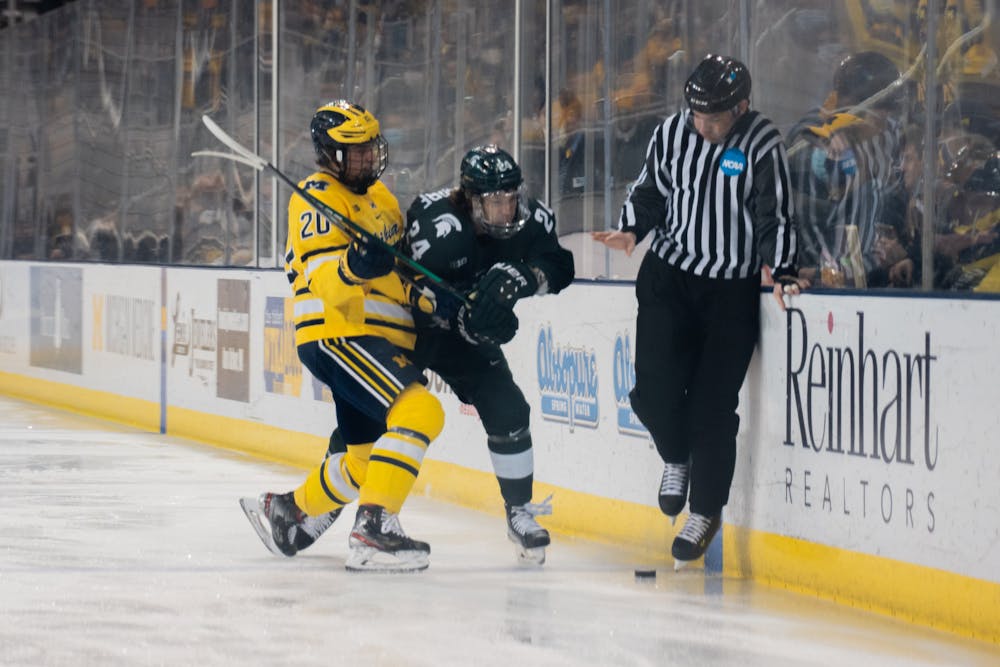 <p>Junior left-wing Erik Middendorf (24) and junior right-defense Keaton Pehrson (20) battle for the puck. MSU&#x27;s hockey season came to an end after a 8-0 loss to the University of Michigan in the Big Ten Men&#x27;s Hockey Tournament at Yost Ice Arena on March 05, 2022.</p>
