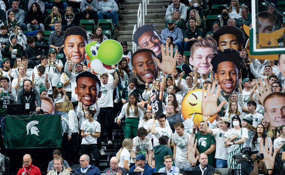 <p>MSU fans hold up face cut-outs of the players during a game against Villanova at the Breslin Center on Nov. 18, 2022. The Spartans defeated the Wildcats 73-71. </p>