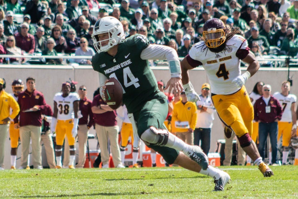 Junior quarterback Brian Lewerke (14) runs toward the end zone to score a touchdown during the game against Central Michigan at Spartan Stadium on Sept. 29, 2018. The Spartans defeated the Chippewas 31-20.