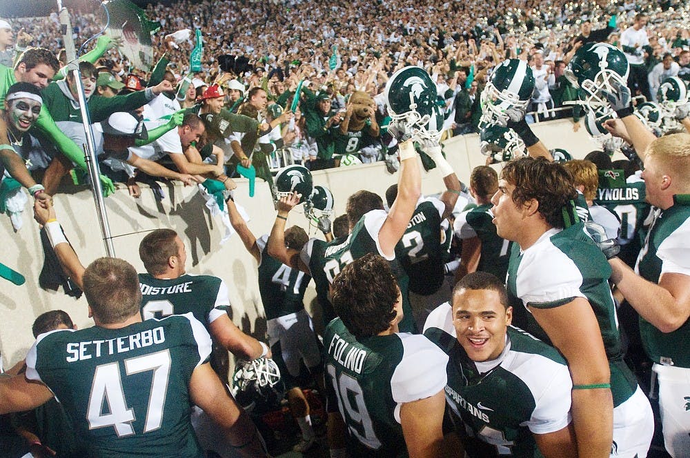 	<p><span class="caps">MSU</span> football players rush the student section after an unexpected touchdown won them the game against Notre Dame on Saturday at Spartan Stadium. A fake field goal turned into a touchdown pass that finished the game, which was already in overtime, with a score of 34-31. Matt Radick/The State News</p>