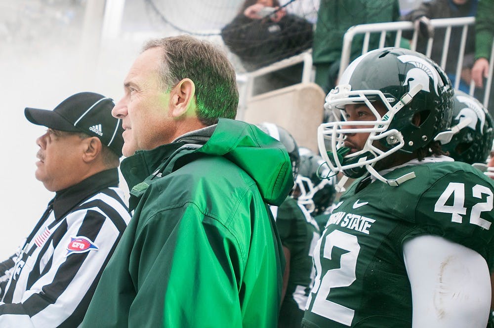 	<p>Head coach Mark Dantonio prepares to head onto the field before the game against Purdue on Oct. 19, 2013, at Spartan Stadium. The Spartans defeated the Boilermakers, 14-0. Khoa Nguyen/The State News</p>