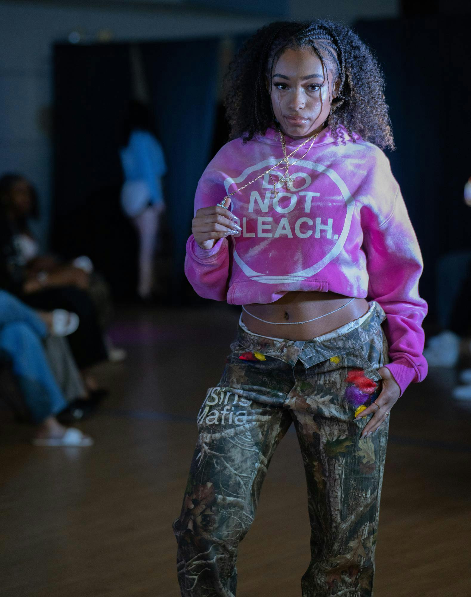 <p>A model poses in a sweater and jeans designed by a clothing brand called 7 Sins Mafia.</p>