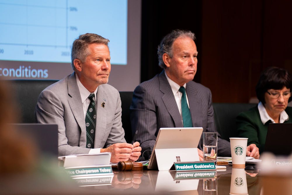 MSU president Kevin Guskiewicz and other trustees listen carefully to a research presentation during a Board of Trustees meeting at the Hannah Administration Building on April 12, 2024.