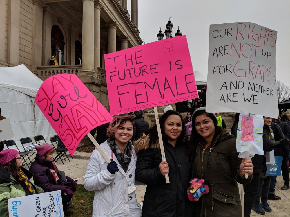 <p>From left to right, Grand Rapids, Michigan, residents Amanda Espinosa, Reyna Espinosa and Cassandra Espinosa pose for a photo during the Women's March on Jan. 21, 2018, at Michigan State Capitol.</p>