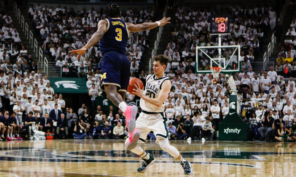 Senior forward Matt McQuaid (20) looks for an opening during the game against Michigan at Breslin Center March 9, 2019. The Spartans defeated the Wolverines, 75-63.
