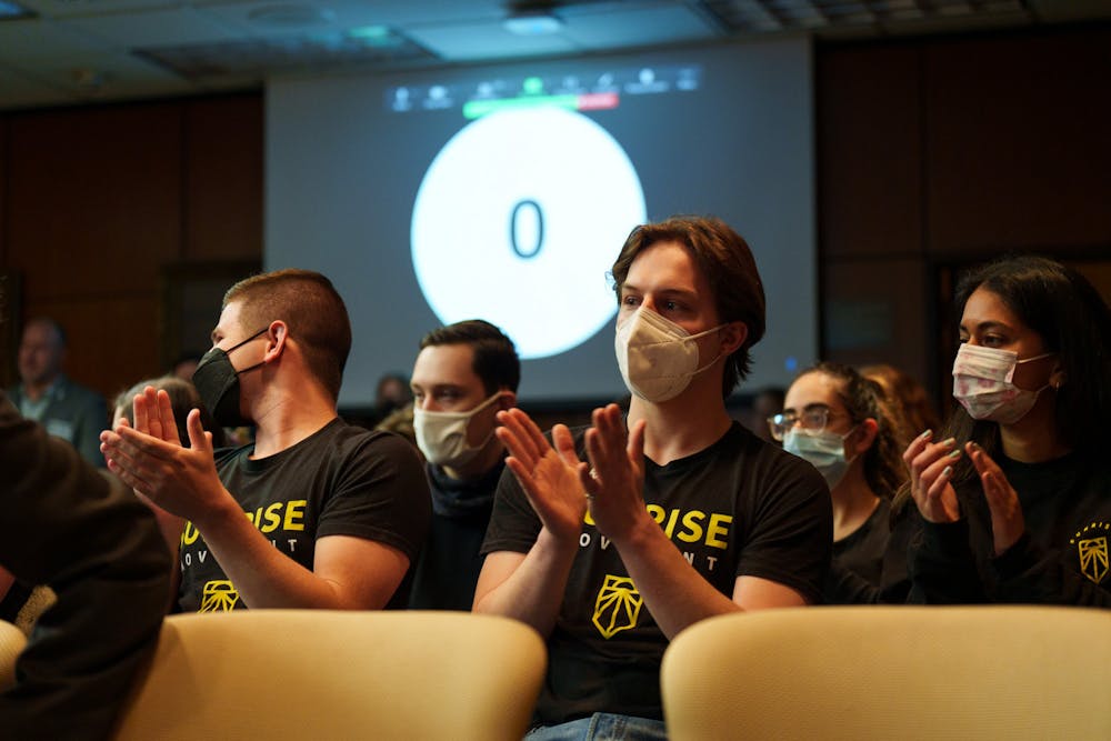 <p>Michigan State Sunrise Movement members clapping after fellow member Truman Forbes spoke during public comment. The Michigan State University Board of Trustees met in the Hannah Administration Building, on April 22, 2022.</p>