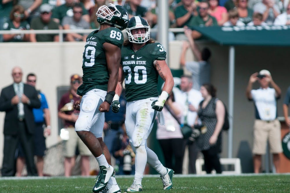<p>Senior defensive end Shilique Calhoun, 89, celebrates after sacking Central Michigan quarterback Cooper Rush for a loss of eight yards in the third quarter during the game against Central Michigan on Sept. 26, 2015, at Spartan Stadium. The Spartans defeated the Chippewas, 30-10. Julia Nagy/The State News </p>