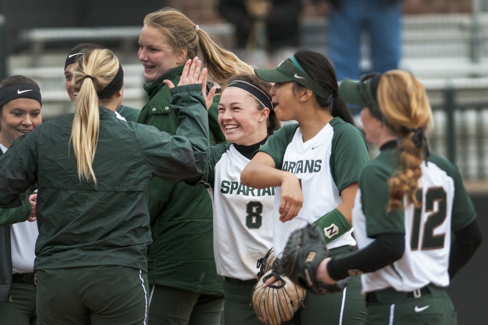 Sophomore utility player Kaitlyn Eveland high-fives her teammates after winning the game against Western Michigan on March 29, 2017 at Secchia Stadium. The Spartans defeated the Broncos, 7-2.