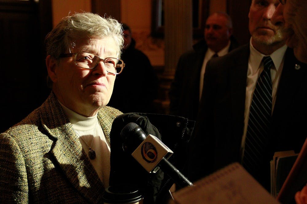 <p>MSU President Lou Anna K. Simon speaks to reporters Feb. 24, 2015, after testifying before a joint meeting of the state house and senate appropriations subcommittees on higher education at the Michigan state Capitol in downtown Lansing. Simon emphasized the ways MSU has cut costs after years of only slight funding increases. Simon Schuster/The State News</p>