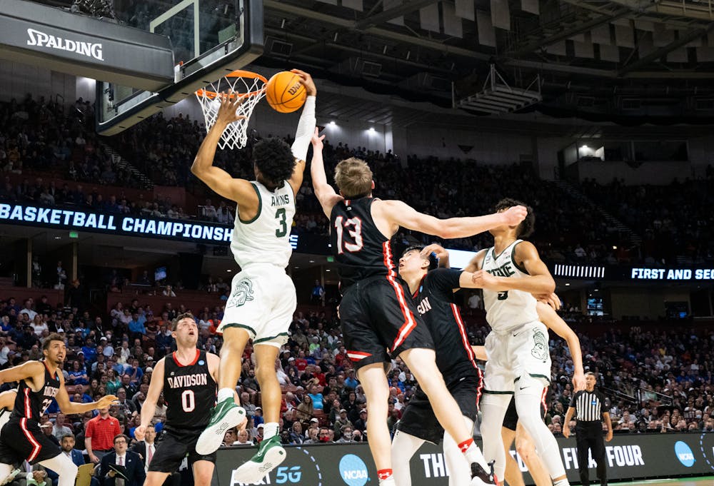 <p>Freshman guard Jaden Akins (3) attempts to score against the Davidson Wildcats on March 18, 2022.</p>