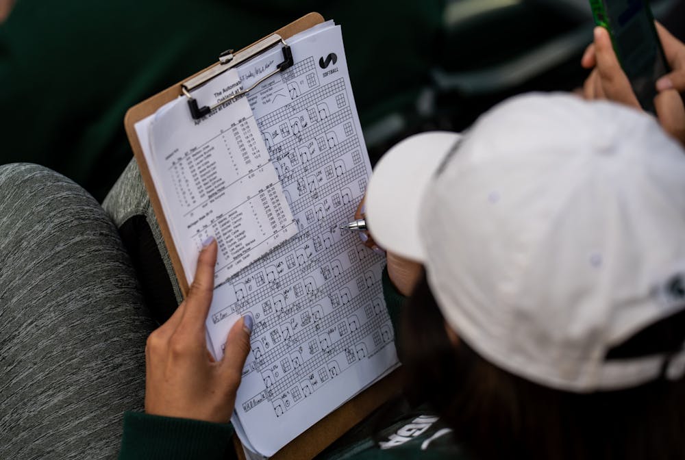 <p>A member in the bleachers keeps score of the game. The Spartans fell to the Golden Grizzlies, 10-5, on April 5, 2022. </p>