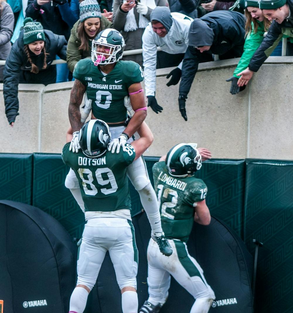 Freshman wide receiver Jalen Nailor (8) is lifted up by sophomore tight end Matt Dotson (89) after scoring a touchdown during the game against Purdue on Oct. 27, 2018 at Spartan Stadium. The Spartans defeated the Boilermakers 23-13.