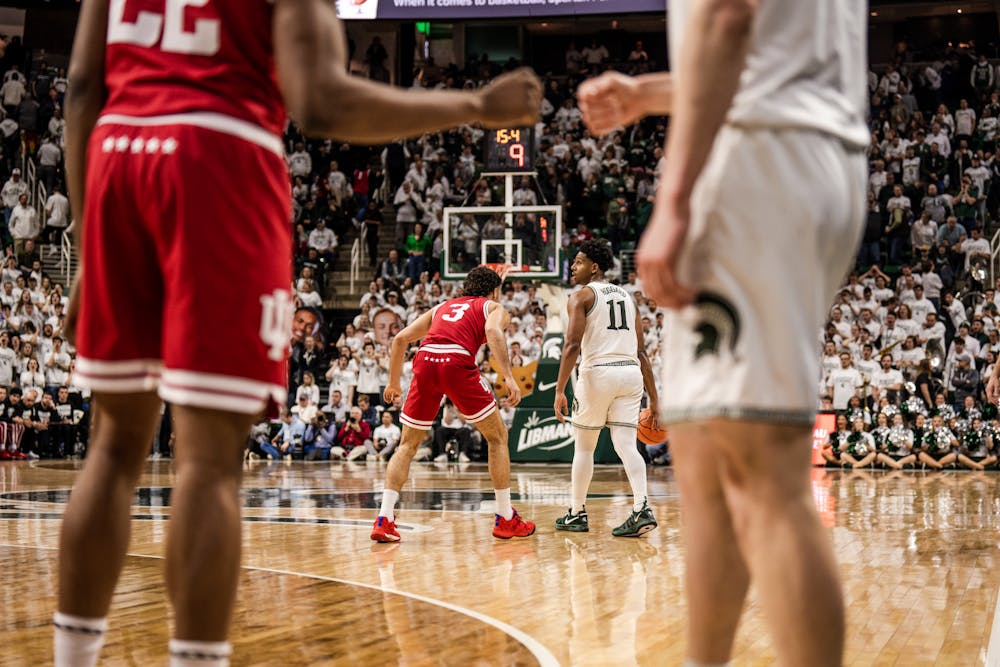 <p>Two opposing players from MSU and Indiana share a fist bump as the final seconds of the match fade away into an 80-65 win against the Hoosiers on Feb. 21, 2023.</p>