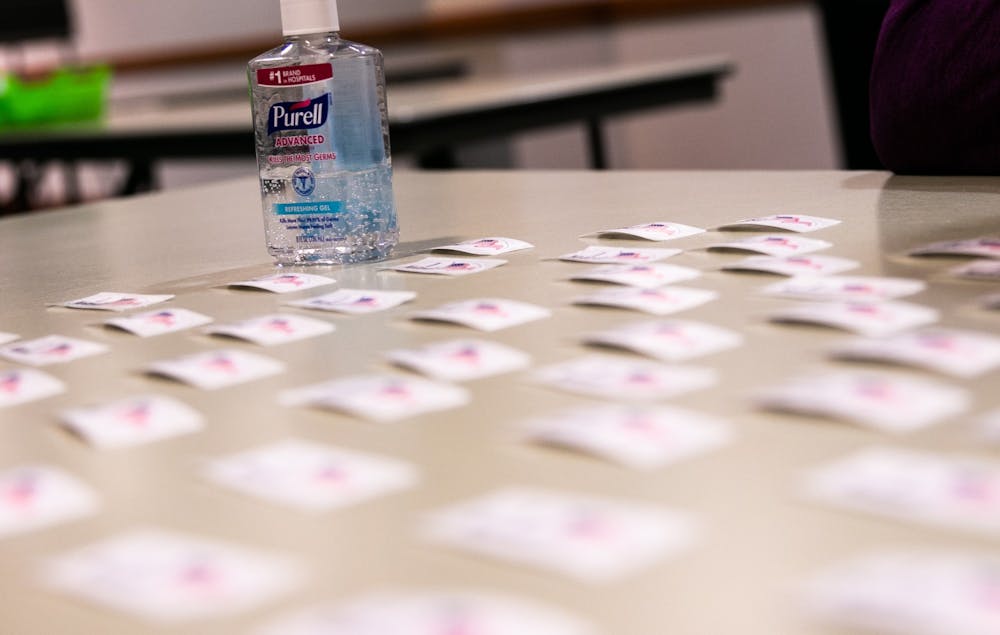 "I Voted" stickers sit next to a bottle of hand sanitizer during the election March 10, 2020.