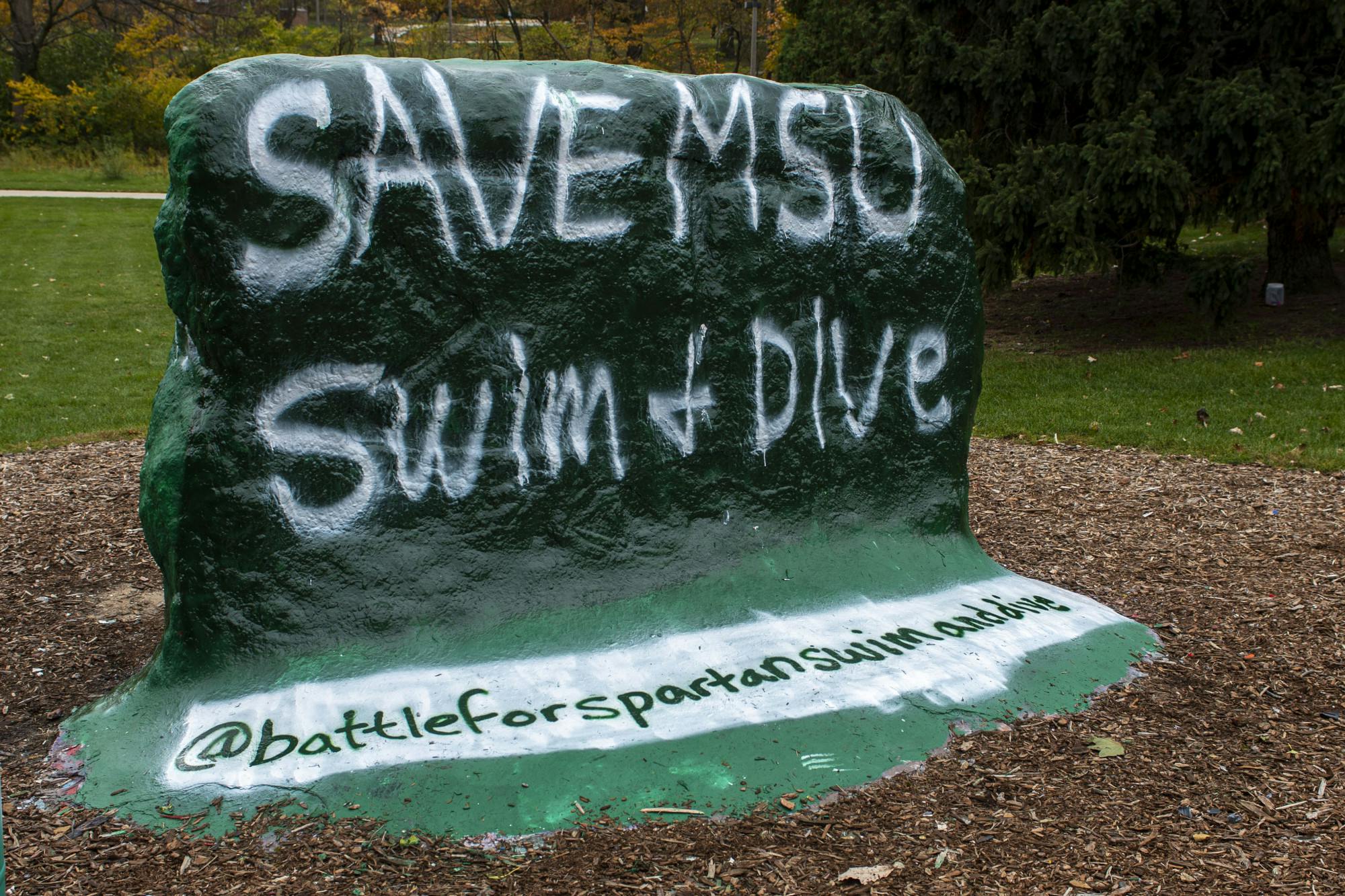 The Rock, located on Farm Lane, is painted to show support against cutting the MSU Swim & Dive program. The university declared Thursday they would stop funding the program after the 2020-21 school year is over. Shot on Oct. 26, 2020. 